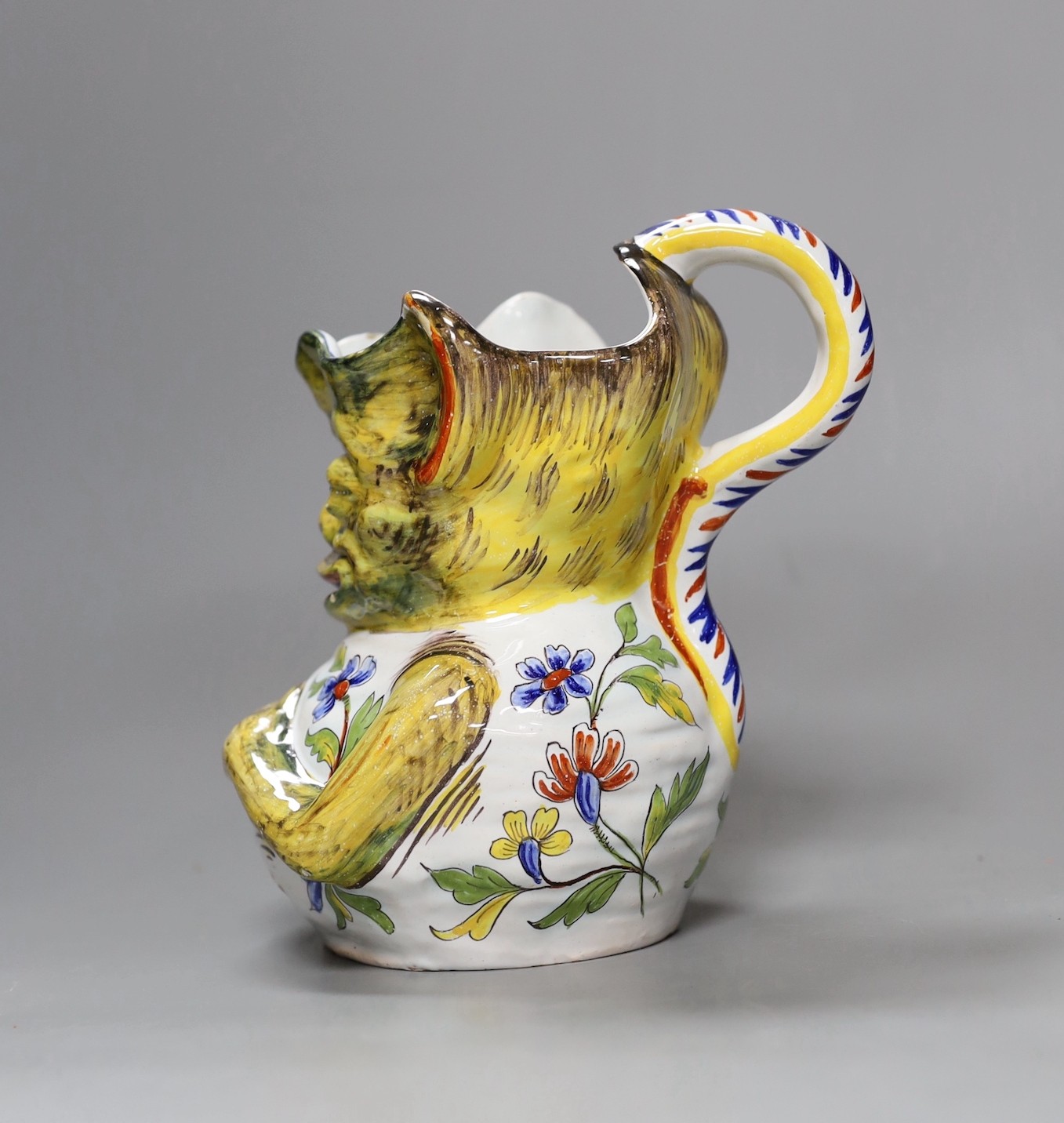 A Rouen faience grotesque jug, 19.5 high